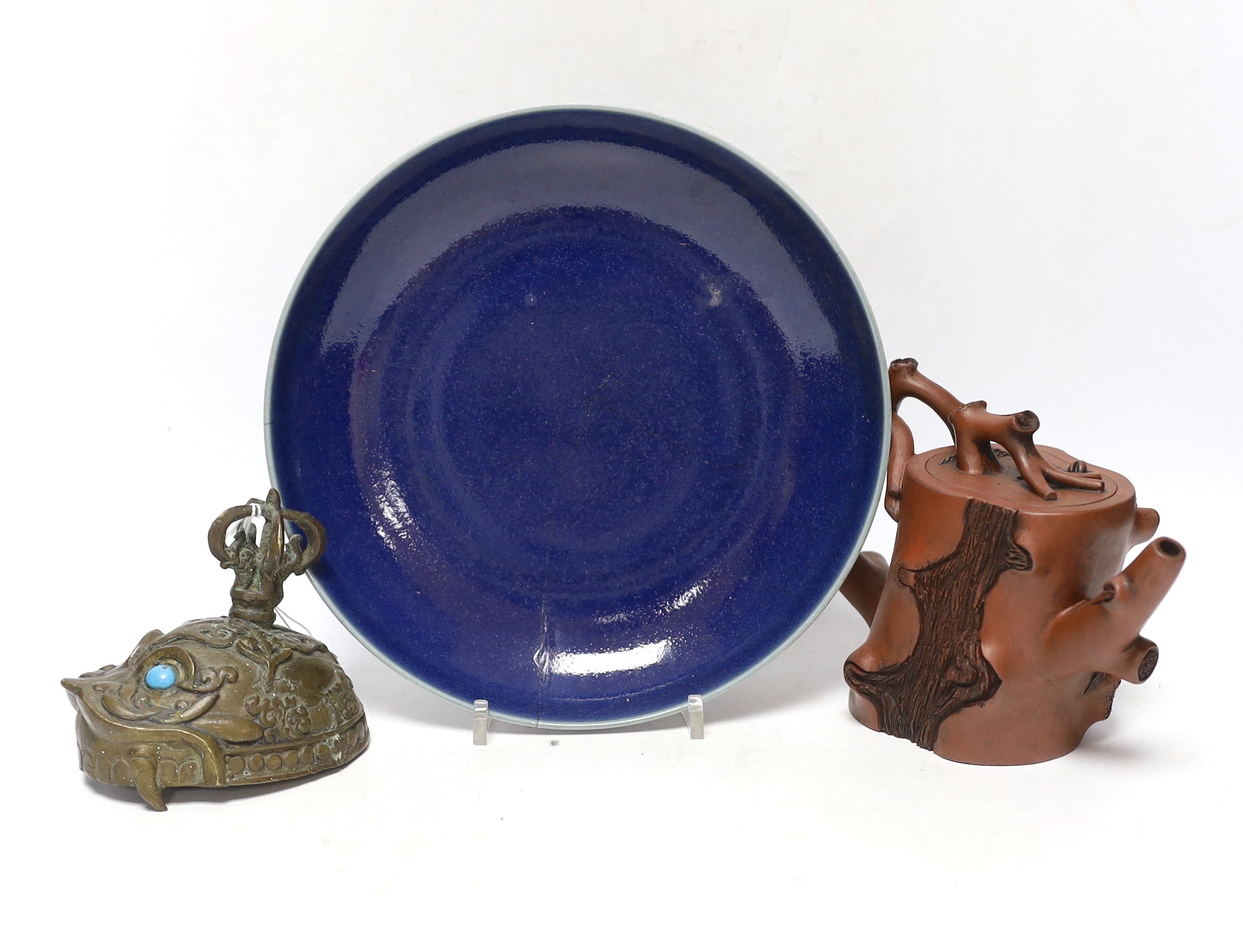 A Chinese Yixing ‘tree branch’ teapot, 13cm, A 20th century Tibetan kapala cover, 9cm and a Chinese blue glazed dish, Yongzheng mark but later, 22.5cm diameter